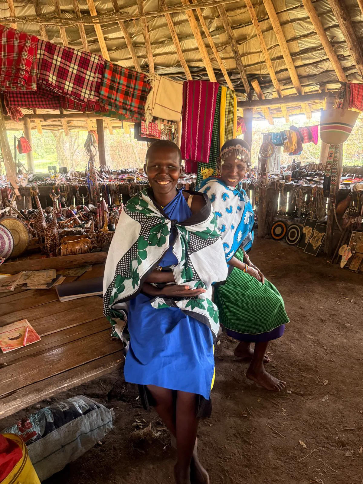 Maasai women artisans welcoming guests at a local craft market near the Maasai Mara